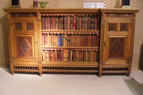fig 1. Rare and Unusual oak stamped Gillow bookcase with carved panels and spindle moulding. C. 1860