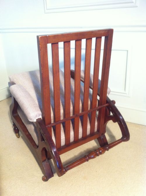 fig 4. Unusual mahogany reclining campaign chair newly upholstered by J Shoolbred.