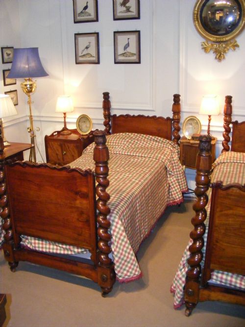 fig 2. A pair of Regency rosewood single bedsteads featuring hand-carved spiral twist corner posts and shaped headboards.