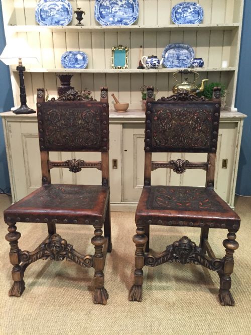 Pair of 17th Century Style Carved Walnut and Embossed Leather Chairs
