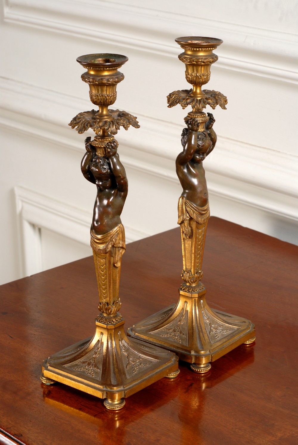 Rare pair of quality Bronze French Empire Cherub candlesticks.