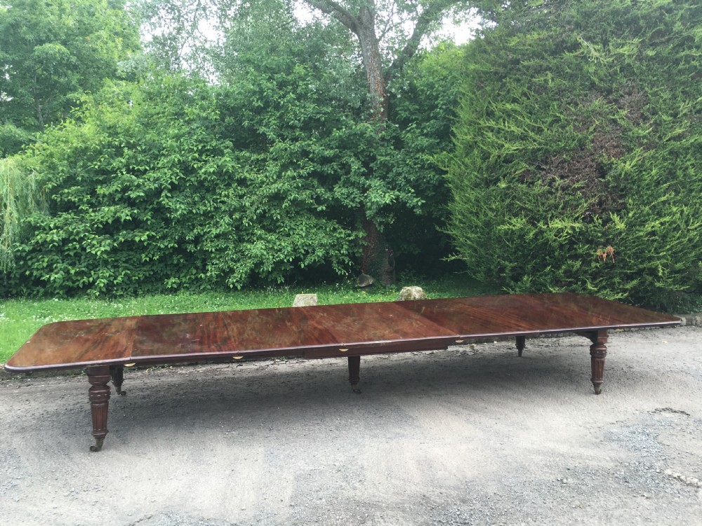 An exceptionally long 19th-century mahogany extending dining table with turned reeded legs set on brass castors.