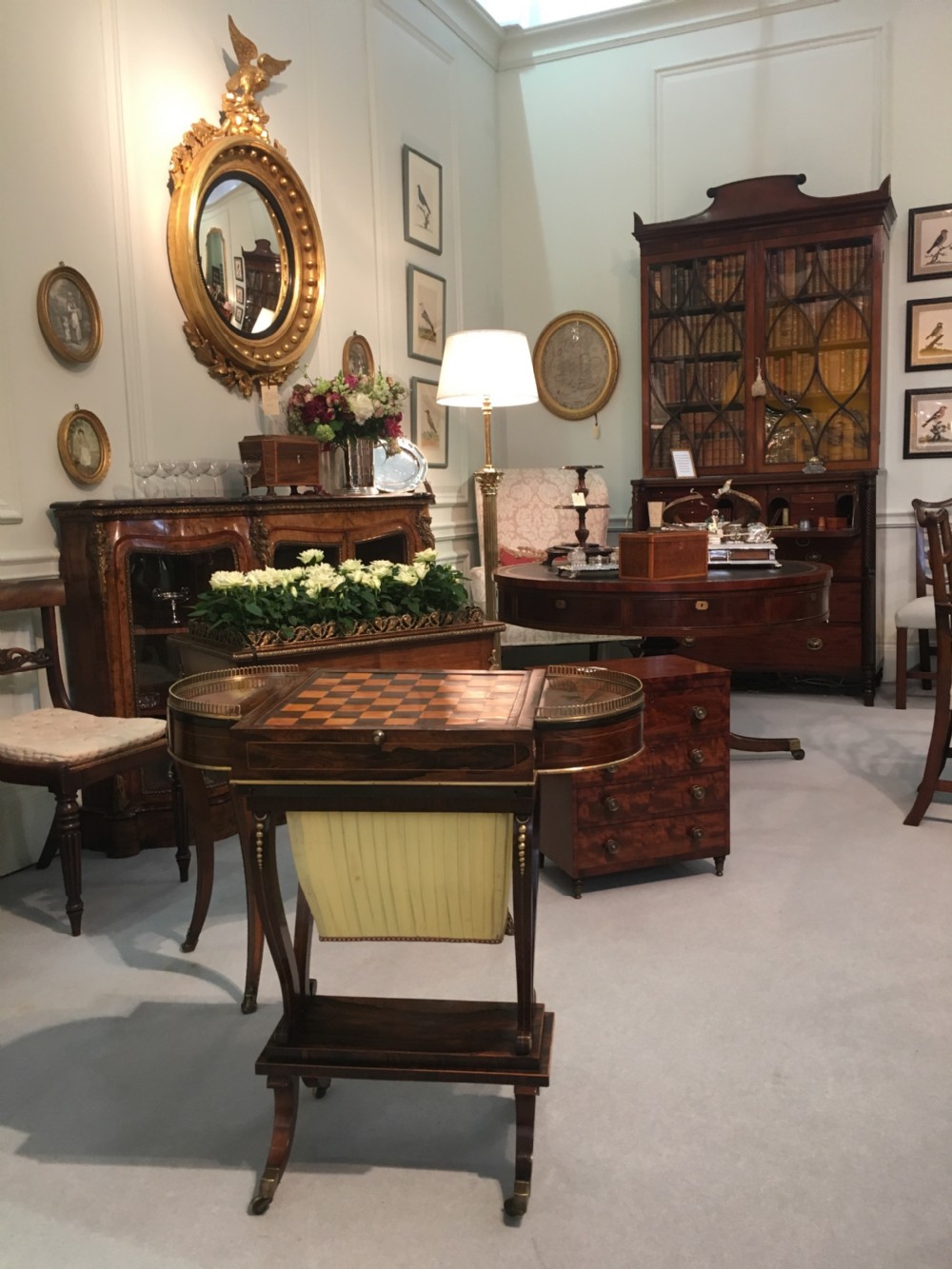 A Regency rosewood games table featuring an inlaid chessboard top, semi-circular brass gallery side tiers, and a pleated silk work bag below. View III