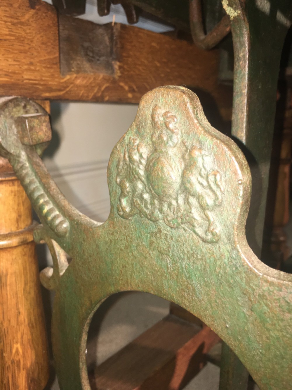 An antique oak jockey scale chair by Young & Son featuring turned legs, rear wheels, a brass balance mechanism, and a set of bell-shaped brass weights. View X
