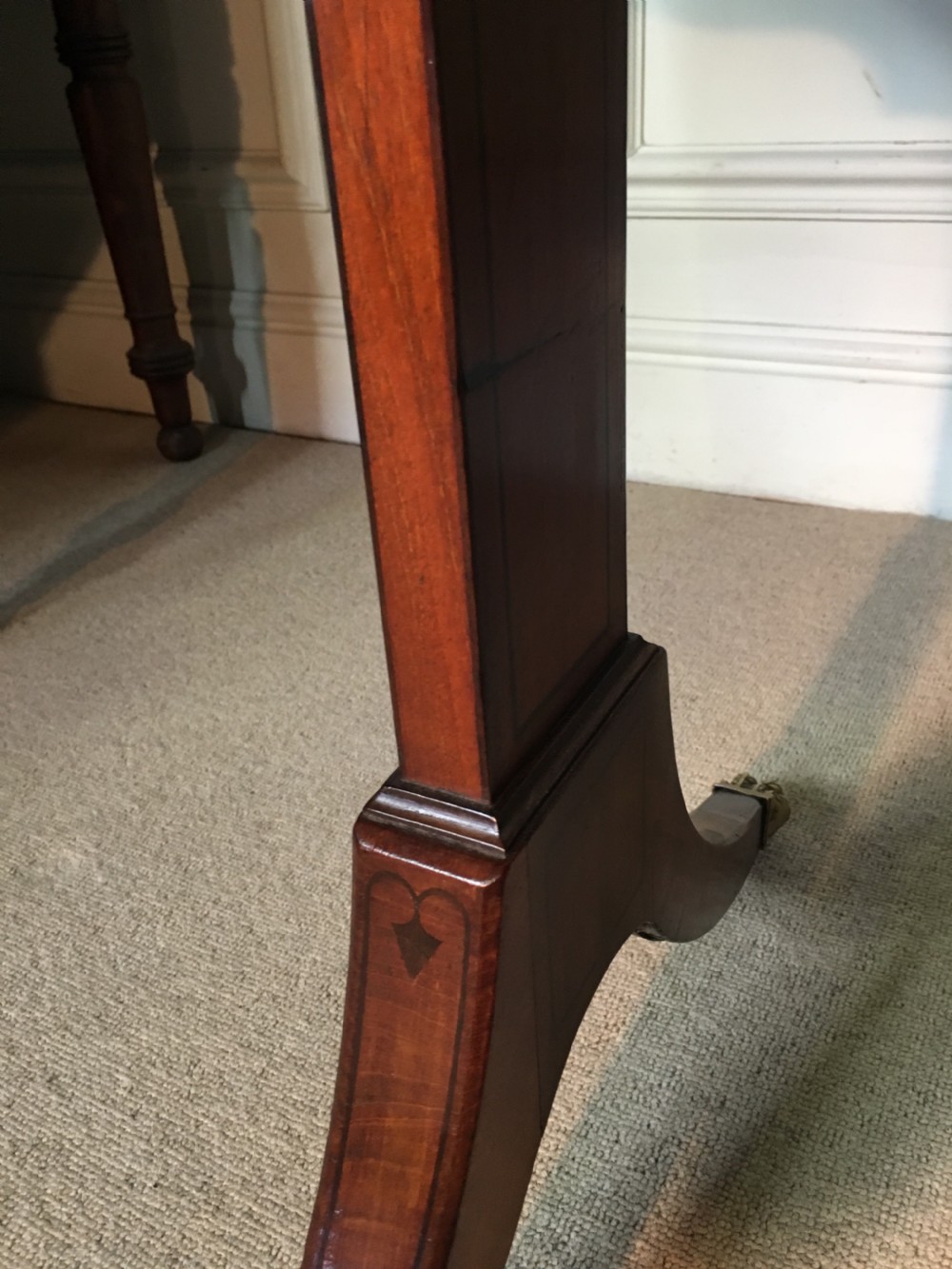 A Georgian mahogany sofa table with two drop leaves, front drawers with brass knobs, and splayed legs ending in brass claw castors. View VIII