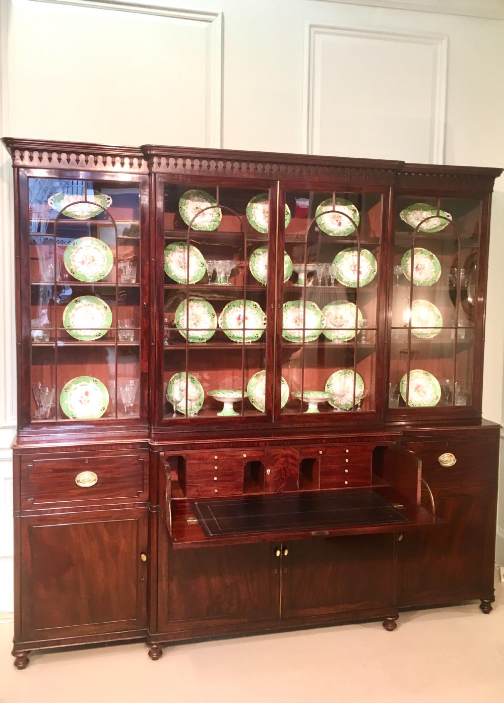 A large Georgian mahogany breakfront bookcase with four upper glazed doors and lower cupboards. View III