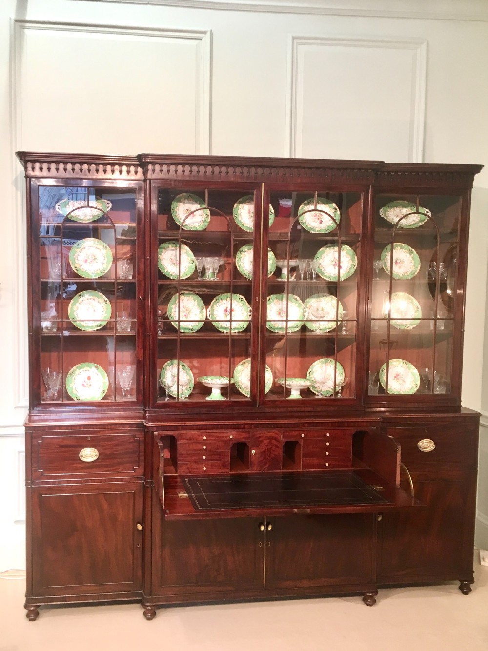 A large Georgian mahogany breakfront bookcase with four upper glazed doors and lower cupboards. View V