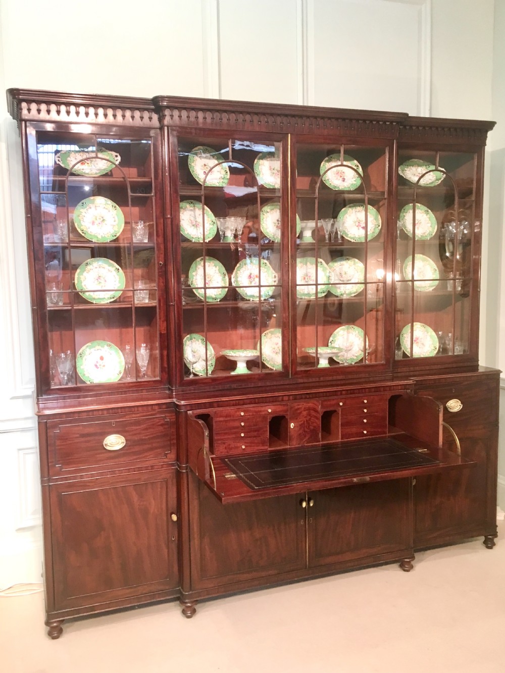 A large Georgian mahogany breakfront bookcase with four upper glazed doors and lower cupboards. View VI