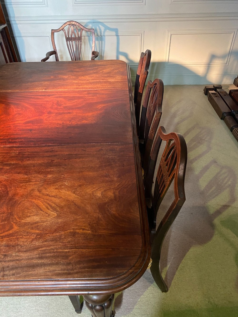 A 19th-century mahogany extending dining table featuring rounded corners, turned and reeded legs, and brass castors. View VIII