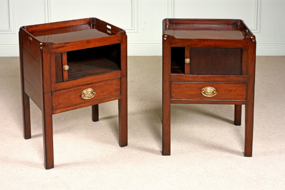A pair of 18th-century George III mahogany bedside commodes featuring tray tops with handles, tambour shutter doors, and brass drawer handles. View II