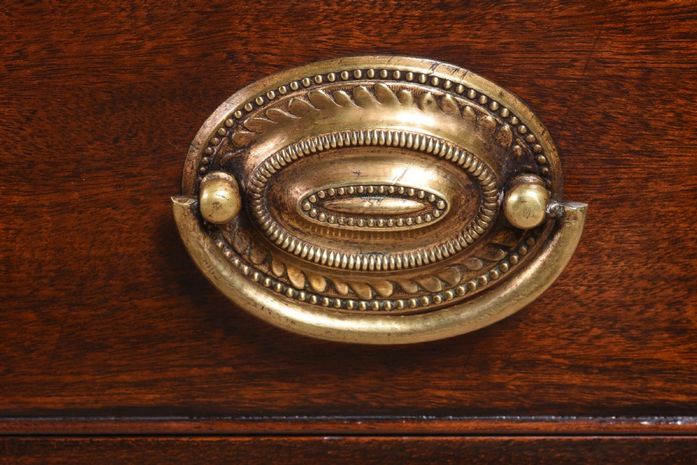 A pair of 18th-century George III mahogany bedside commodes featuring tray tops with handles, tambour shutter doors, and brass drawer handles. View VIII