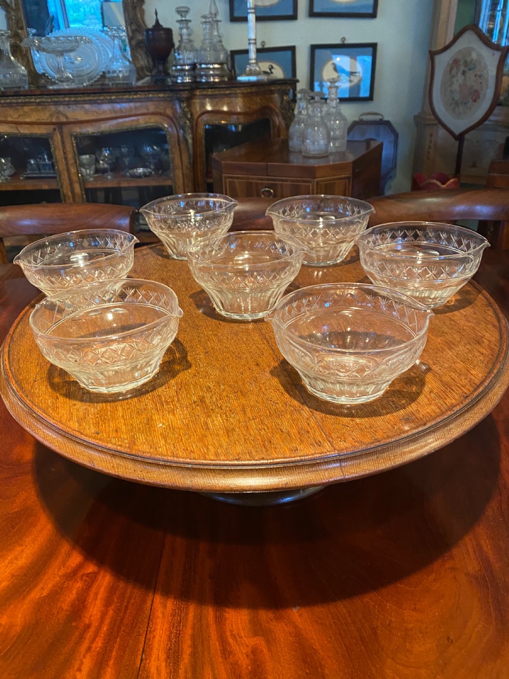 A set of seven 19th-century clear cut crystal finger bowls with diamond-patterned borders and small lip spouts. View II
