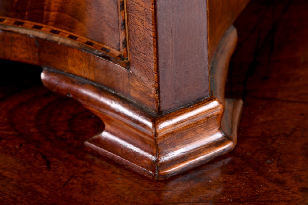 An antique George III mahogany dressing table mirror featuring an oval swing glass on curved supports above a serpentine base with three inlaid drawers. View VII