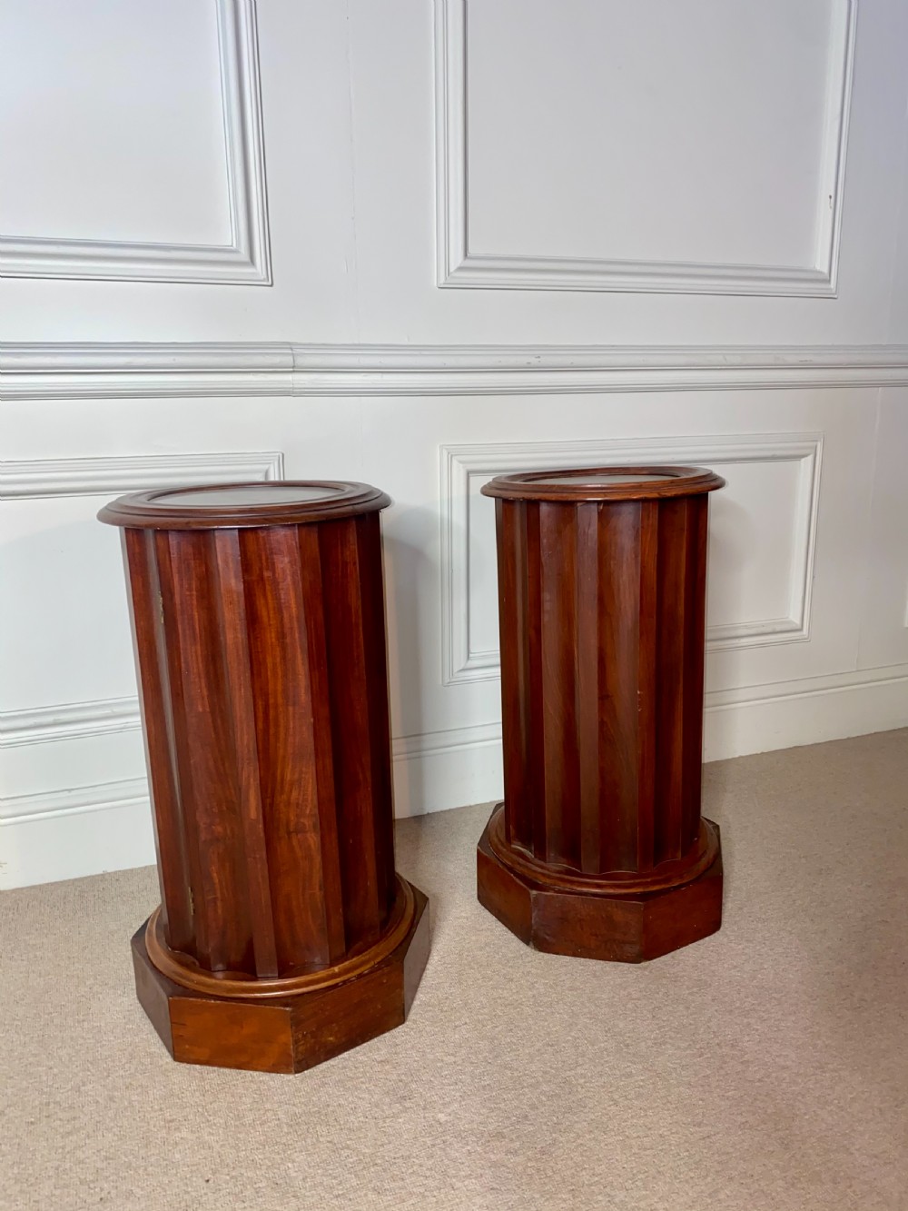 A pair of cylindrical mahogany bedside stands featuring fluted wooden columns, inset marble tops, and octagonal plinth bases. View III