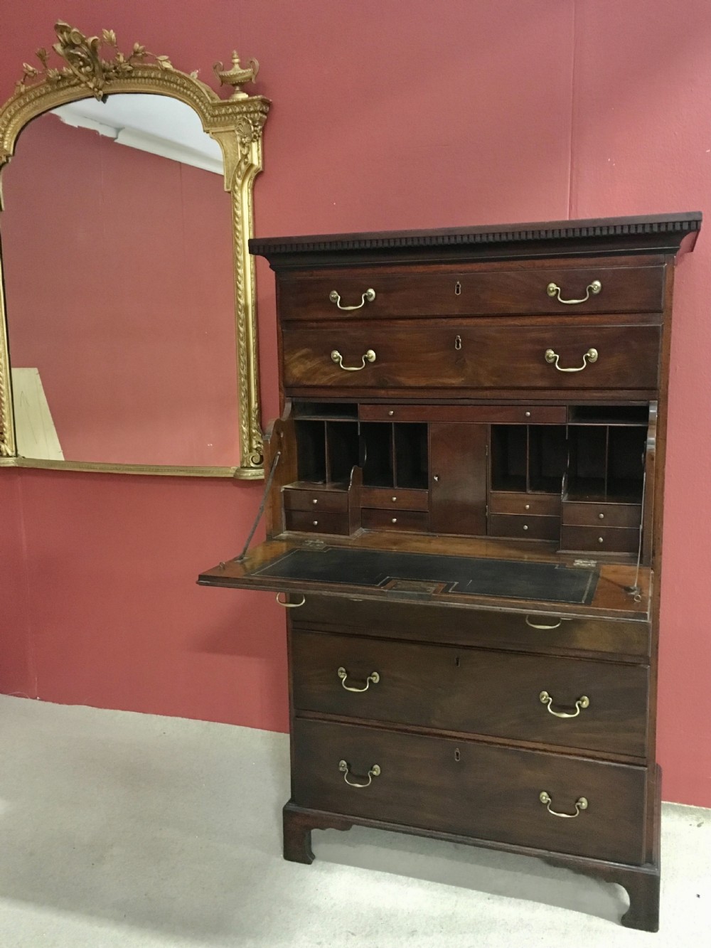 A tall George III mahogany secretaire tallboy featuring seven graduated drawers, brass swan-neck handles, dentil moulding, and bracket feet. View VII