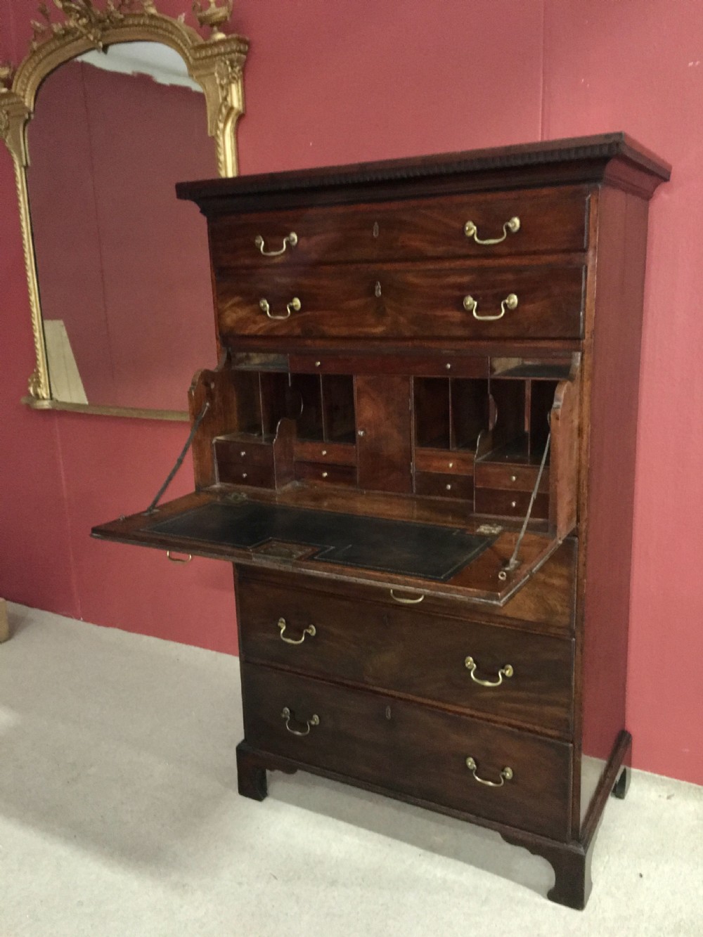 A tall George III mahogany secretaire tallboy featuring seven graduated drawers, brass swan-neck handles, dentil moulding, and bracket feet. View IX