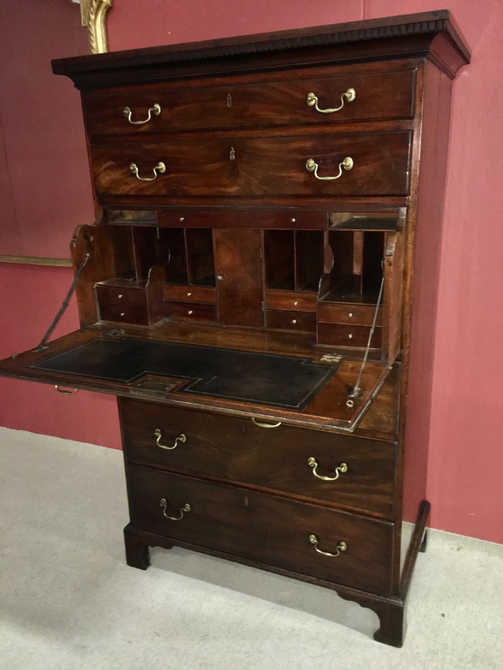 A tall George III mahogany secretaire tallboy featuring seven graduated drawers, brass swan-neck handles, dentil moulding, and bracket feet. View X
