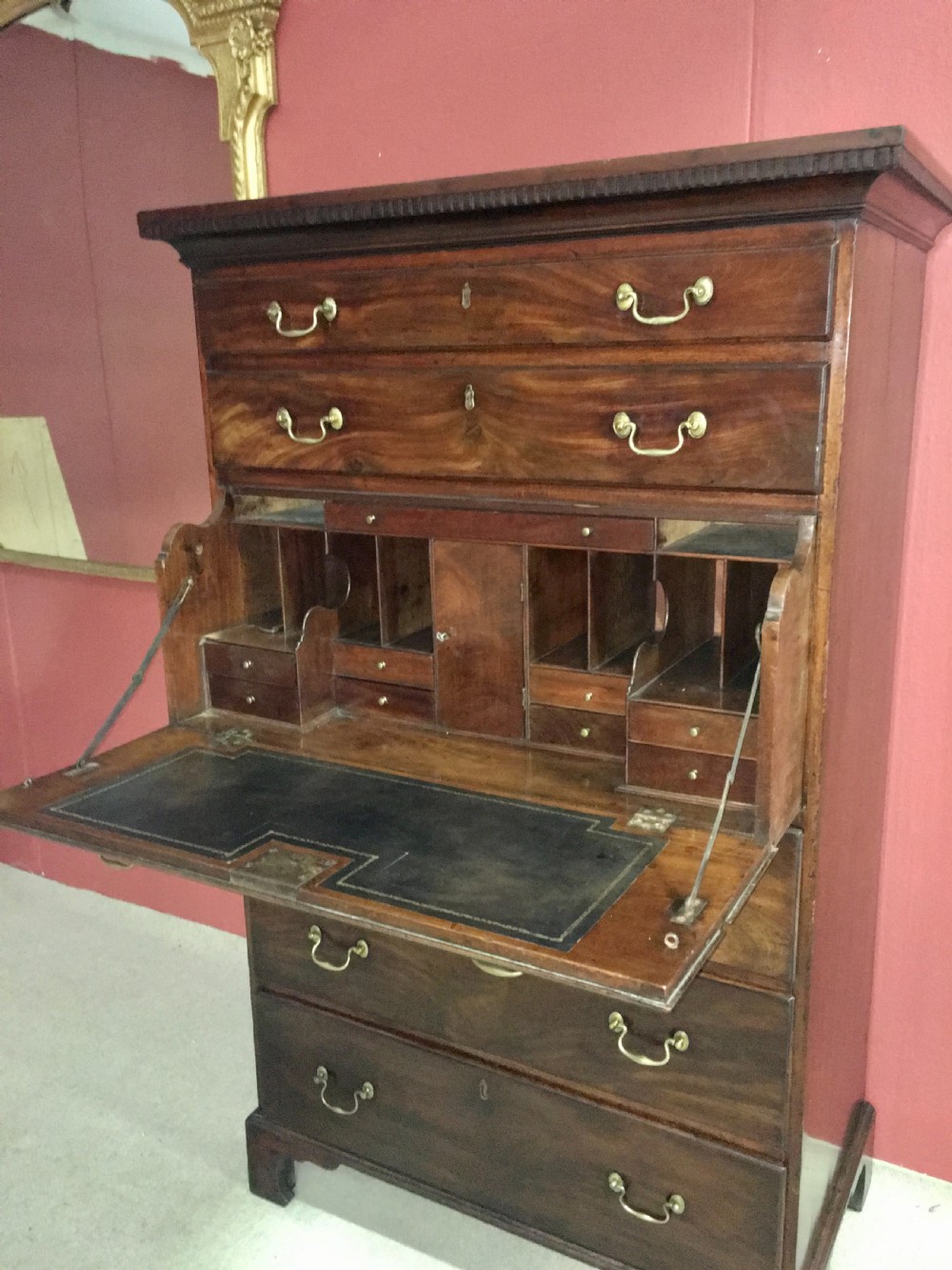 A tall George III mahogany secretaire tallboy featuring seven graduated drawers, brass swan-neck handles, dentil moulding, and bracket feet. View XI