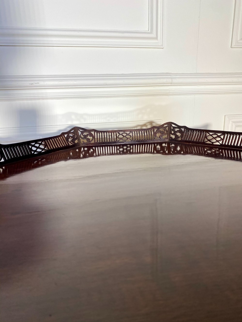 An 18th-century mahogany octagonal tripod table featuring a pierced fretwork gallery, fluted central column, and carved cabriole legs. View VII