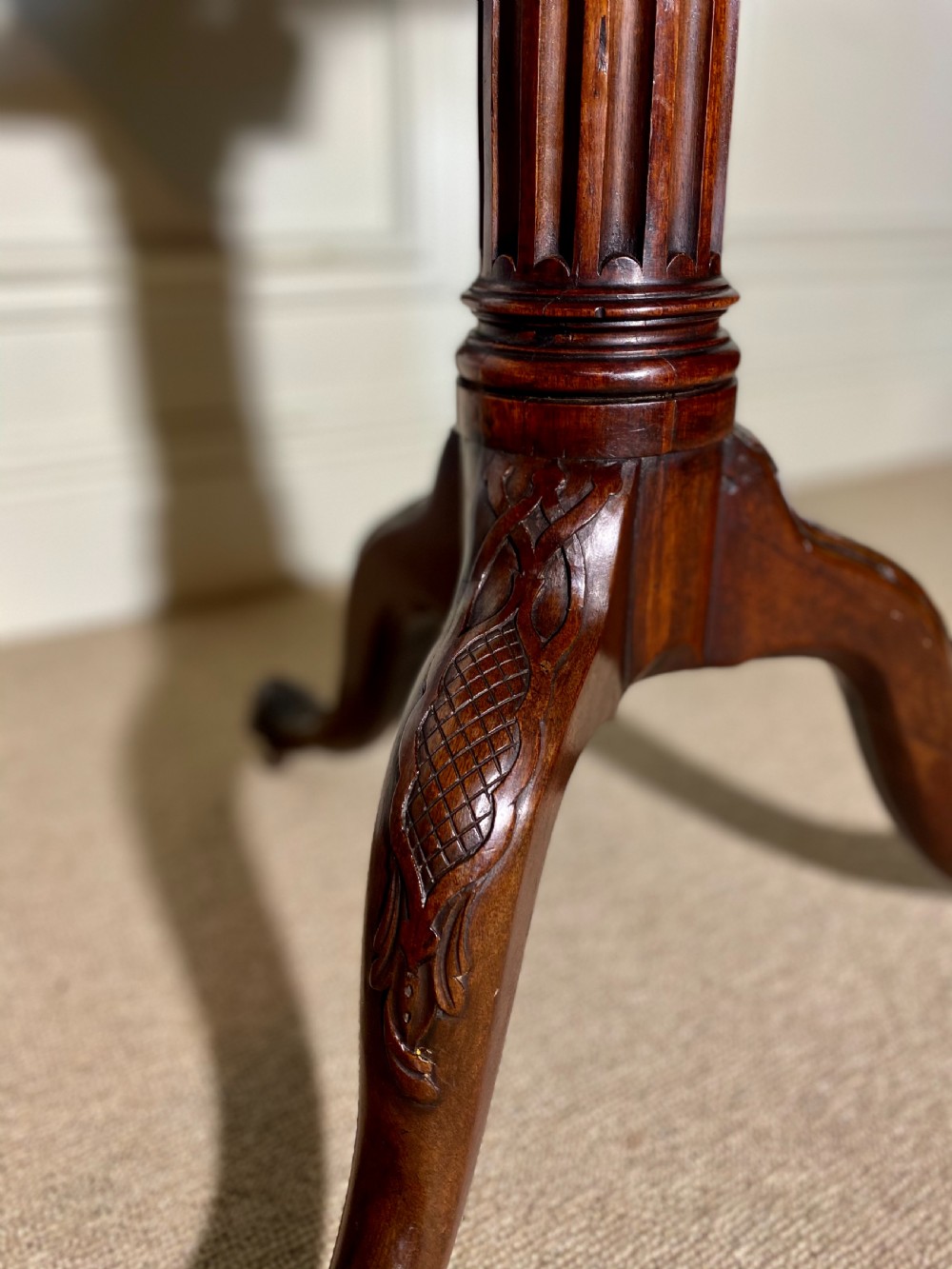 An 18th-century mahogany octagonal tripod table featuring a pierced fretwork gallery, fluted central column, and carved cabriole legs. View IX