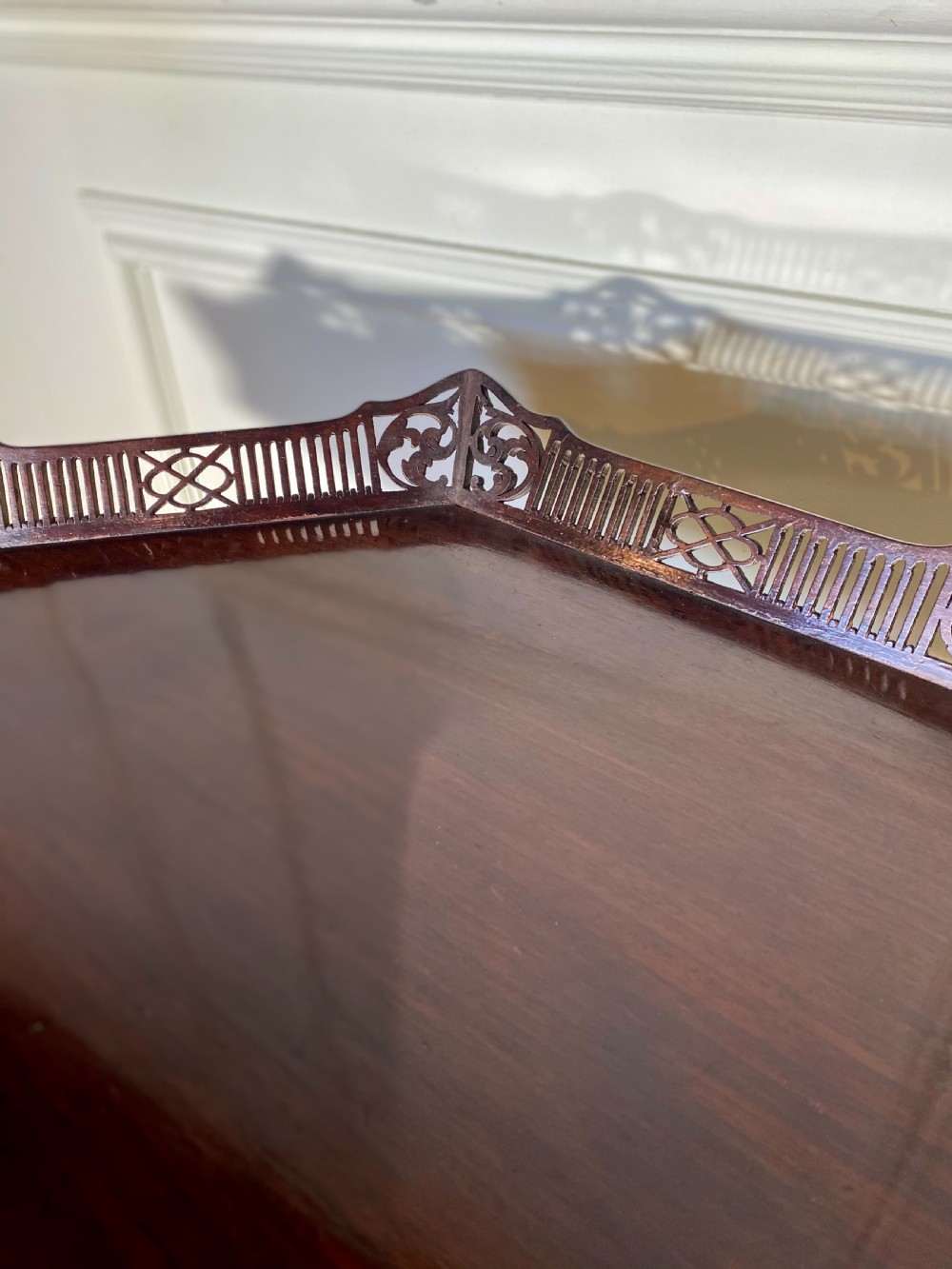 An 18th-century mahogany octagonal tripod table featuring a pierced fretwork gallery, fluted central column, and carved cabriole legs. View XI
