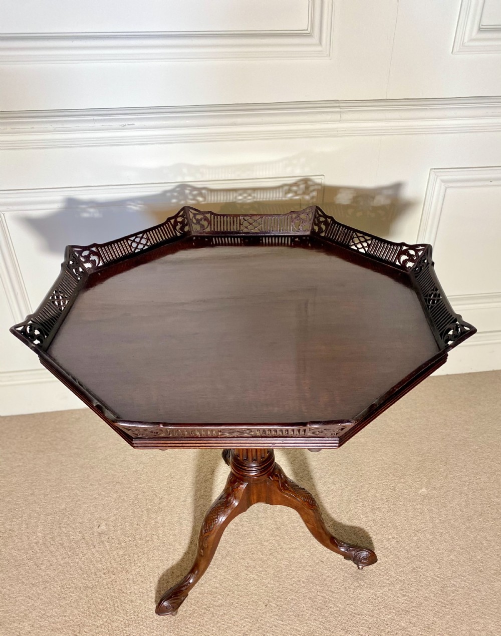 An 18th-century mahogany octagonal tripod table featuring a pierced fretwork gallery, fluted central column, and carved cabriole legs. View XIII