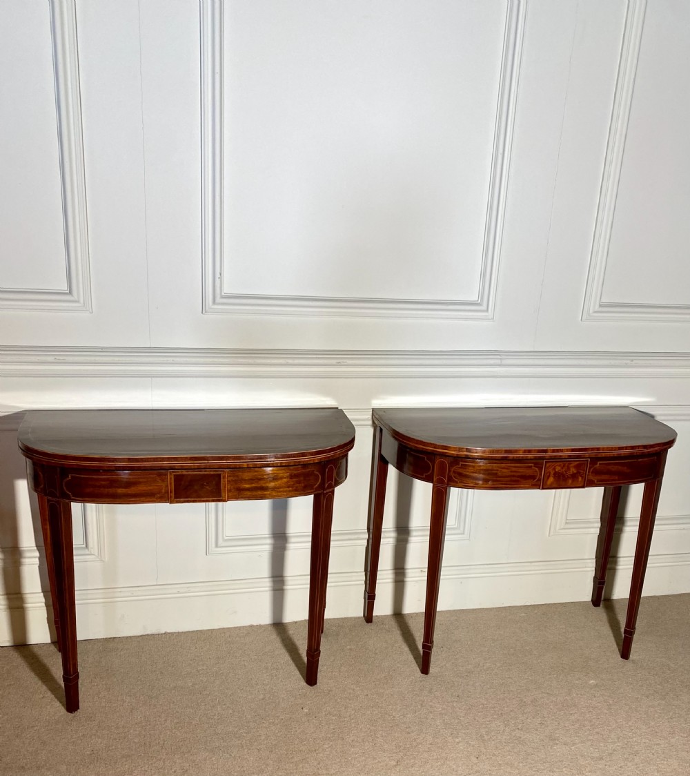 A pair of 18th-century George III mahogany demilune card tables with satinwood crossbanding, boxwood stringing, and square tapered legs. View IV