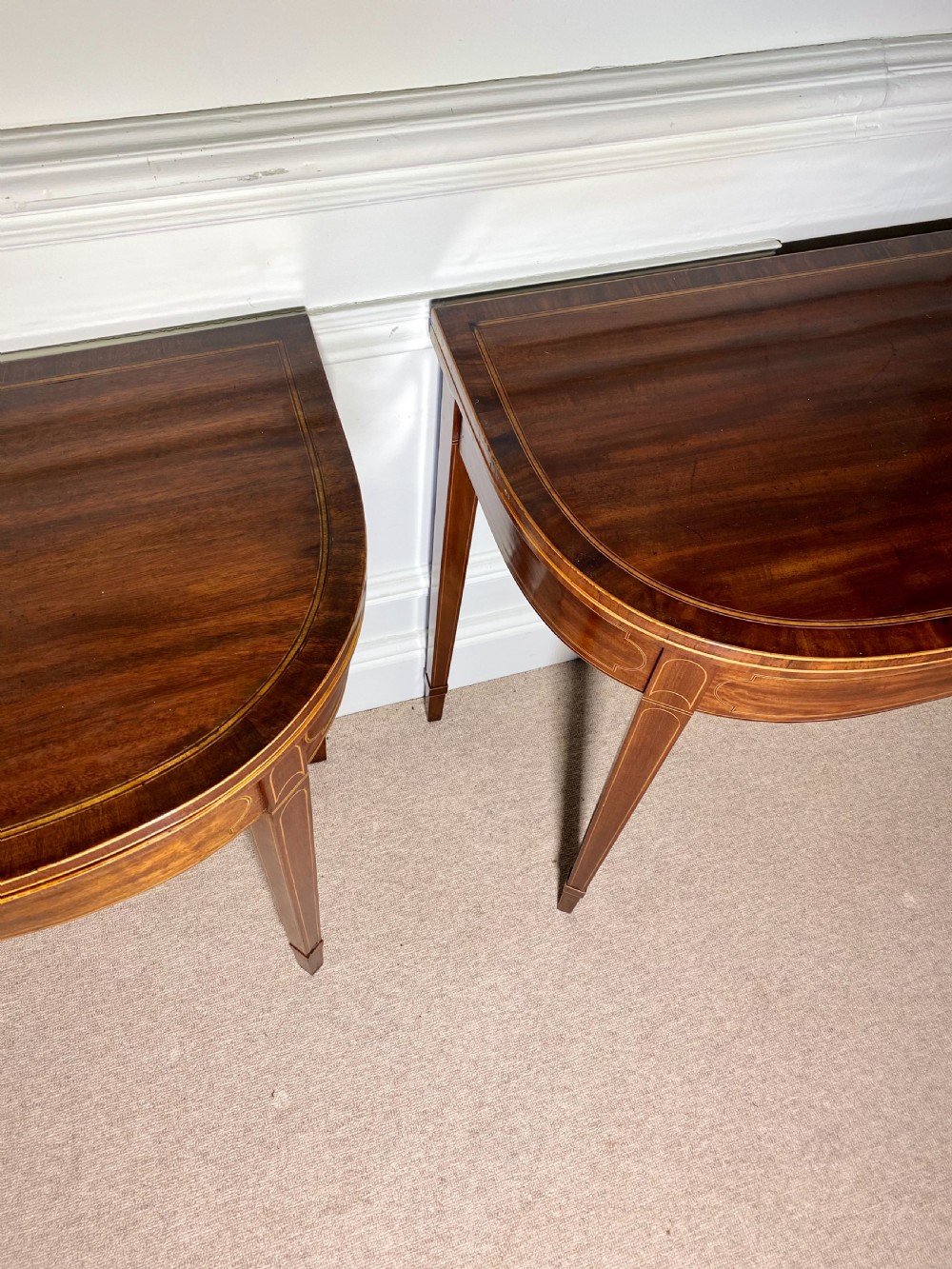 A pair of 18th-century George III mahogany demilune card tables with satinwood crossbanding, boxwood stringing, and square tapered legs. View VII