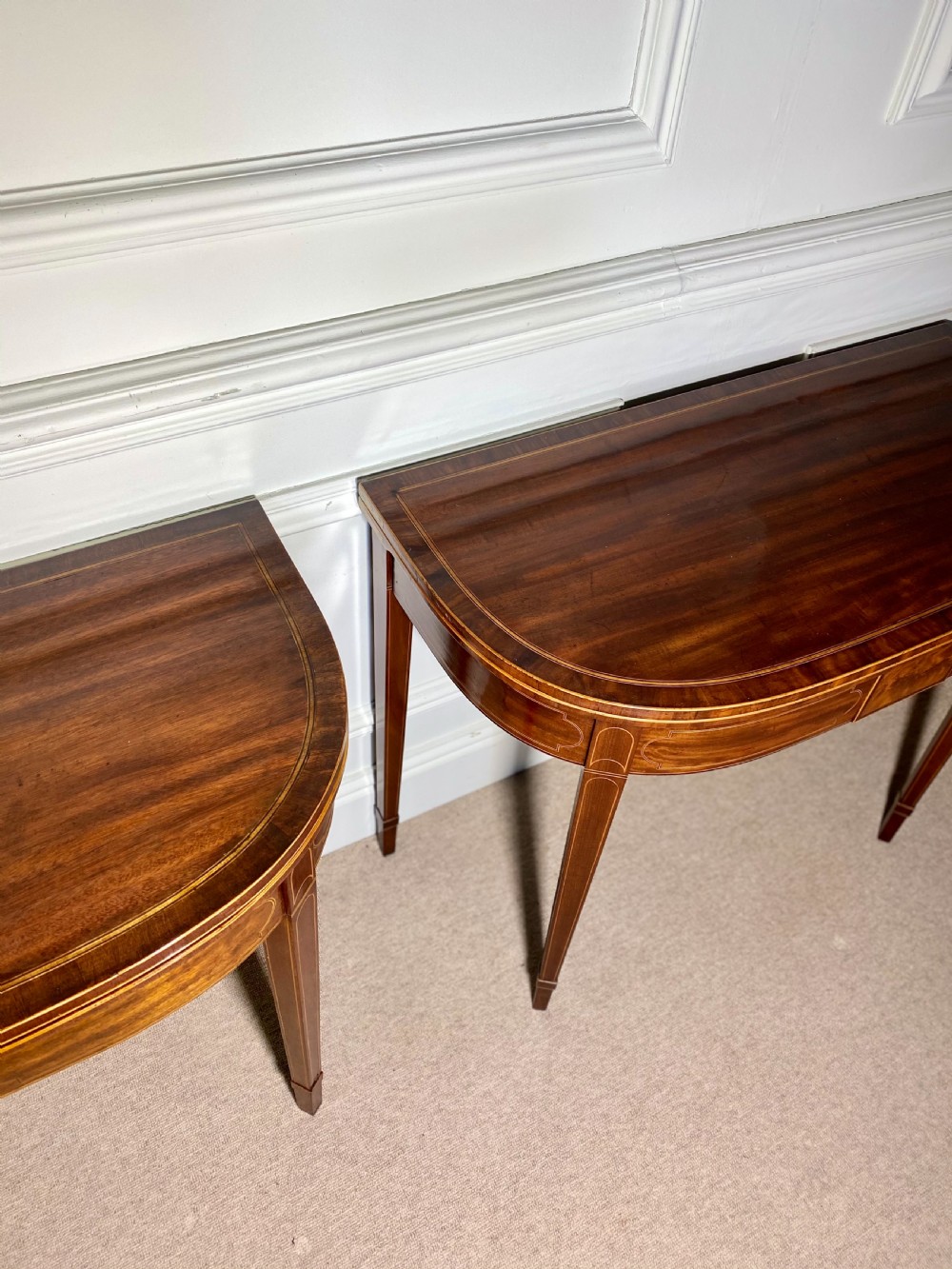 A pair of 18th-century George III mahogany demilune card tables with satinwood crossbanding, boxwood stringing, and square tapered legs. View VIII