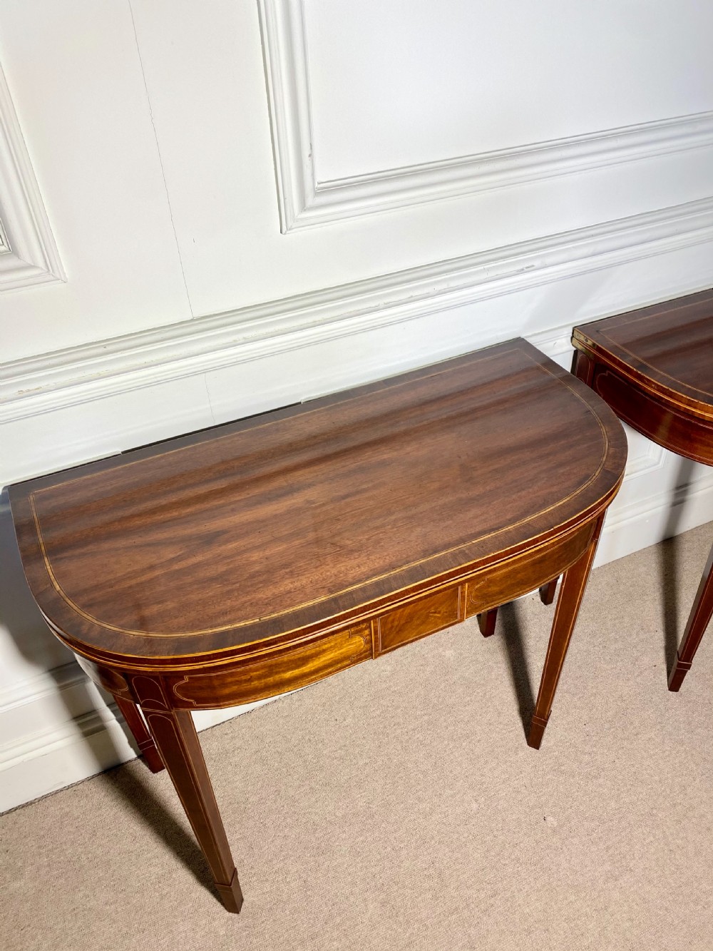 A pair of 18th-century George III mahogany demilune card tables with satinwood crossbanding, boxwood stringing, and square tapered legs. View XI
