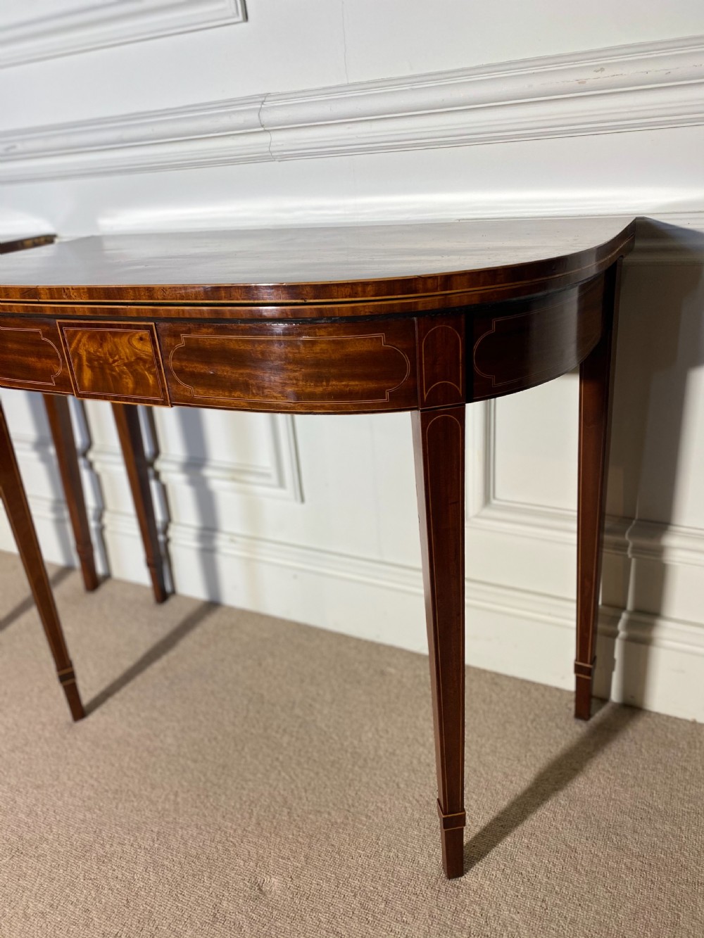 A pair of 18th-century George III mahogany demilune card tables with satinwood crossbanding, boxwood stringing, and square tapered legs. View XII