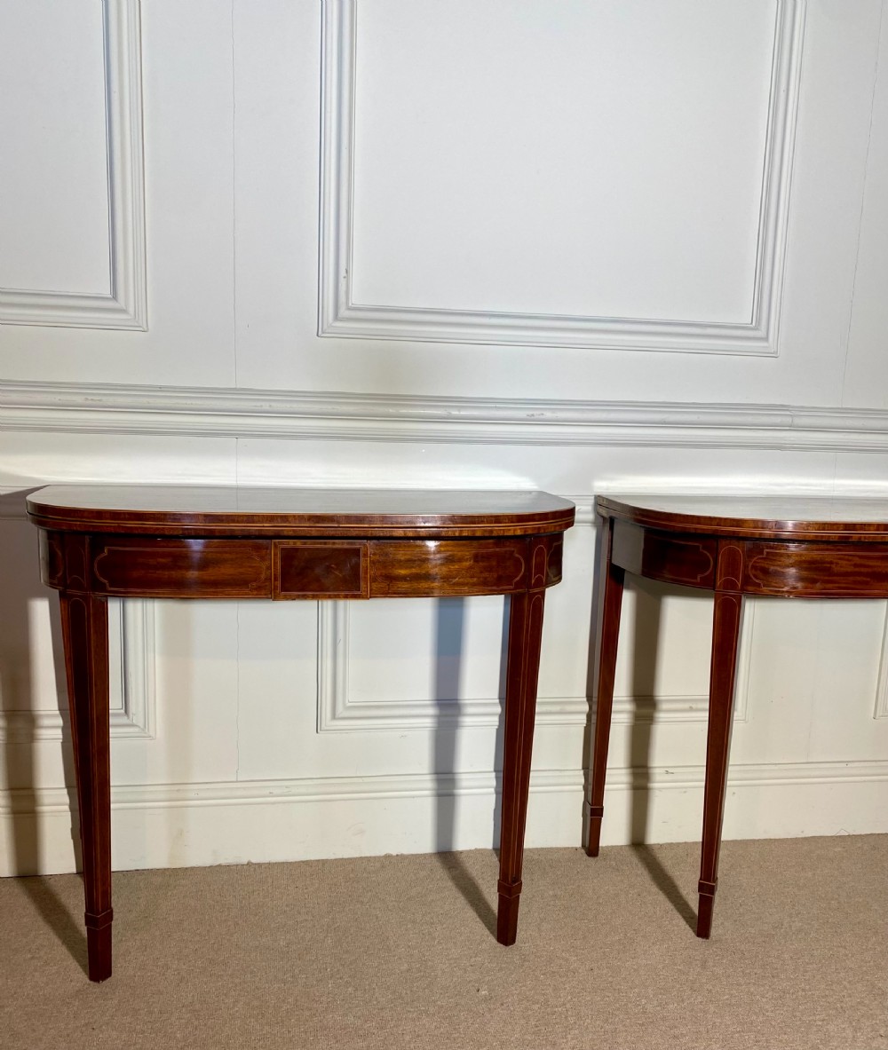 A pair of 18th-century George III mahogany demilune card tables with satinwood crossbanding, boxwood stringing, and square tapered legs. View XIII