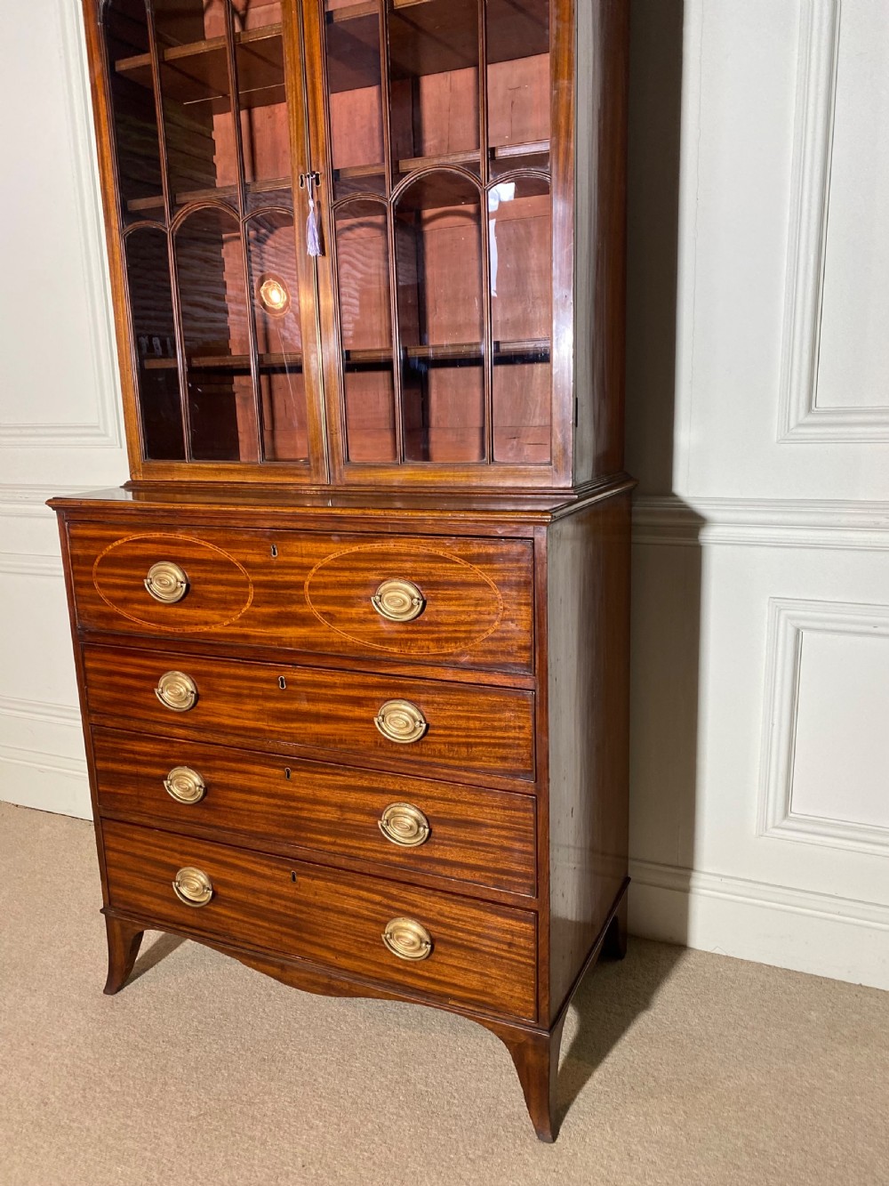 An 18th-century George III mahogany secretaire bookcase featuring an upper double-door glazed cabinet with arched astragal glazing, an open drop-front writing drawer with internal pigeonholes, and lower drawers with brass oval handles. View XII
