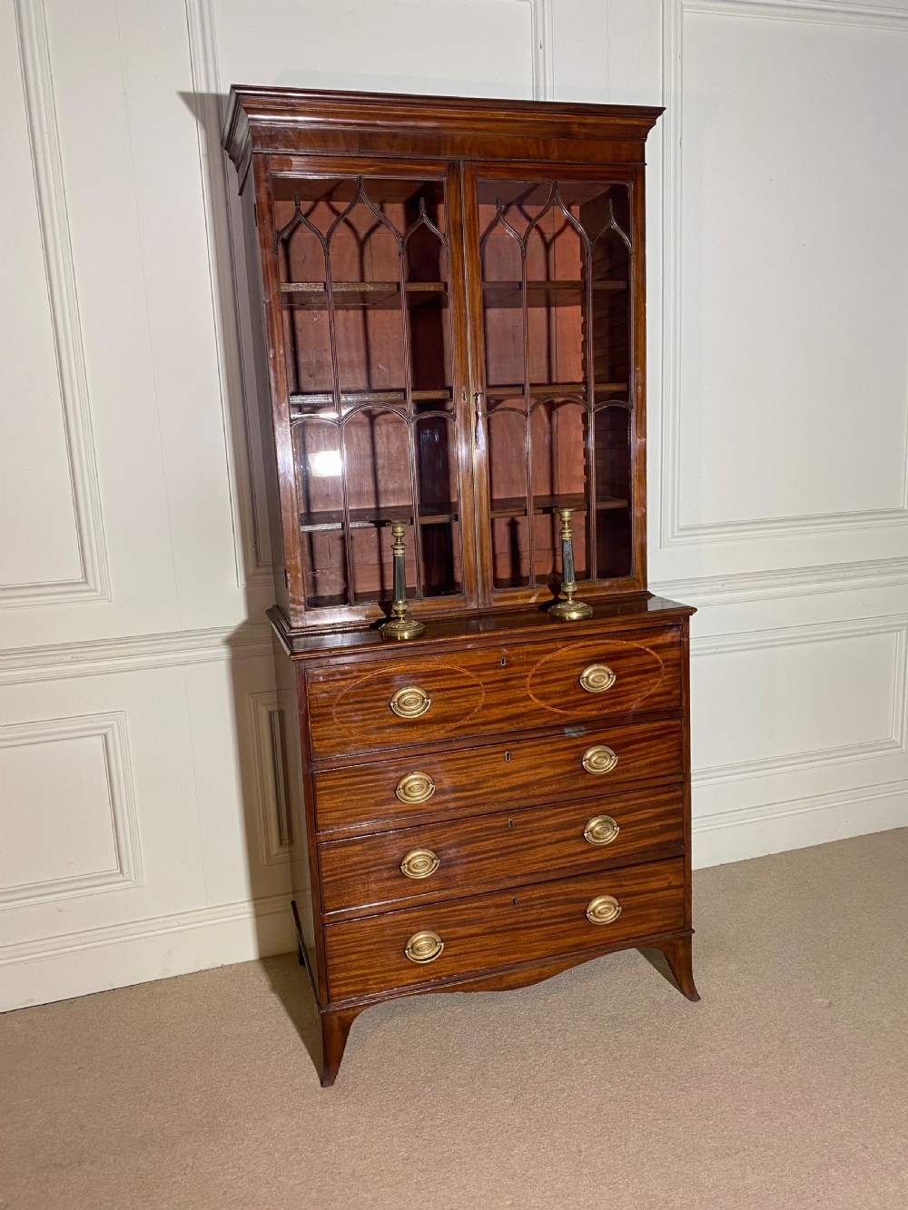 An 18th-century George III mahogany secretaire bookcase featuring an upper double-door glazed cabinet with arched astragal glazing, an open drop-front writing drawer with internal pigeonholes, and lower drawers with brass oval handles. View XIII