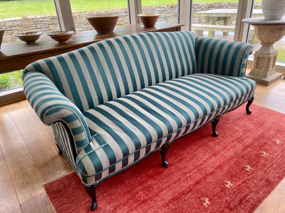 A 19th-century scroll arm sofa upholstered in green and beige striped fabric with dark carved cabriole legs. View II
