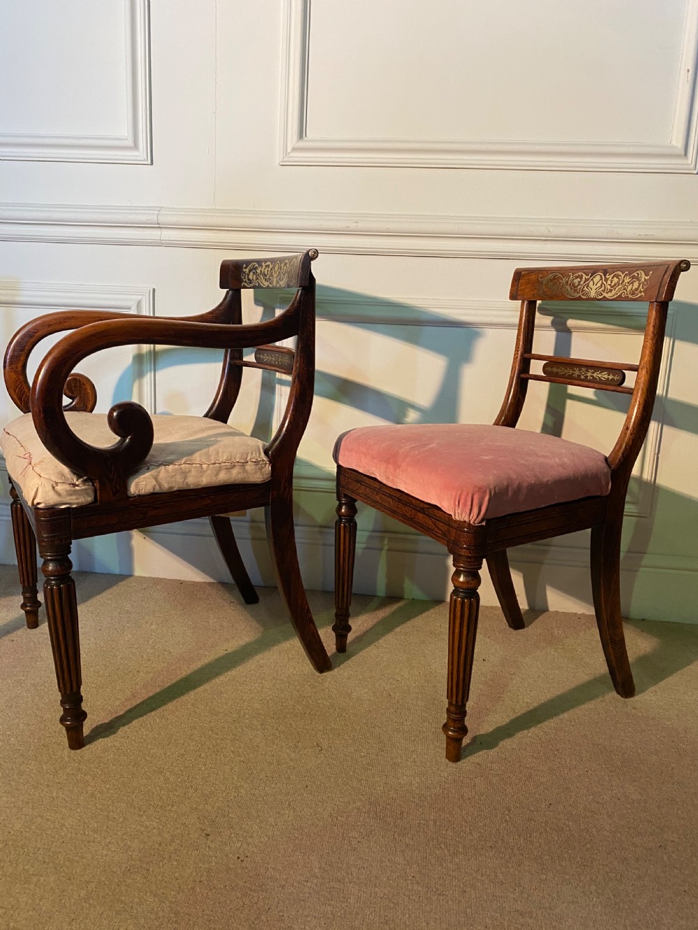 A set of Regency wooden dining chairs featuring brass inlay on the top rails, turned fluted legs, and upholstered drop-in seats. View II