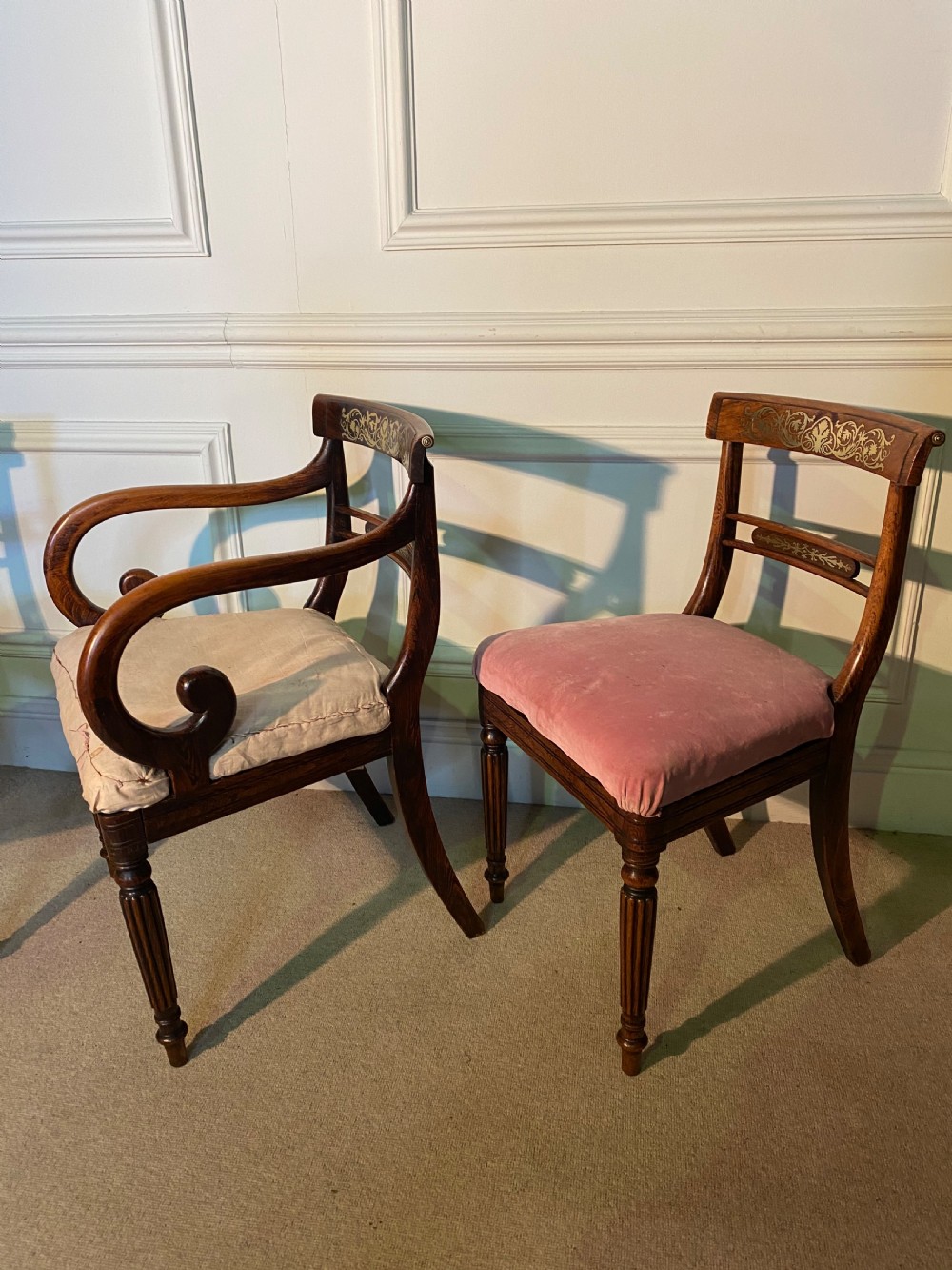 A set of Regency wooden dining chairs featuring brass inlay on the top rails, turned fluted legs, and upholstered drop-in seats. View III