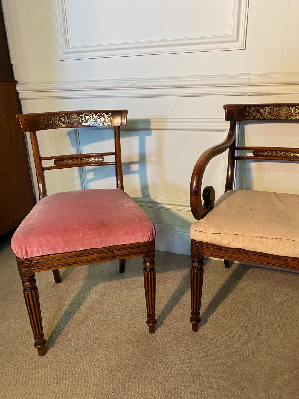 A set of Regency wooden dining chairs featuring brass inlay on the top rails, turned fluted legs, and upholstered drop-in seats. View IV