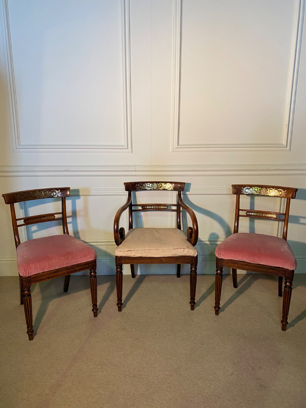 A set of Regency wooden dining chairs featuring brass inlay on the top rails, turned fluted legs, and upholstered drop-in seats. View VIII