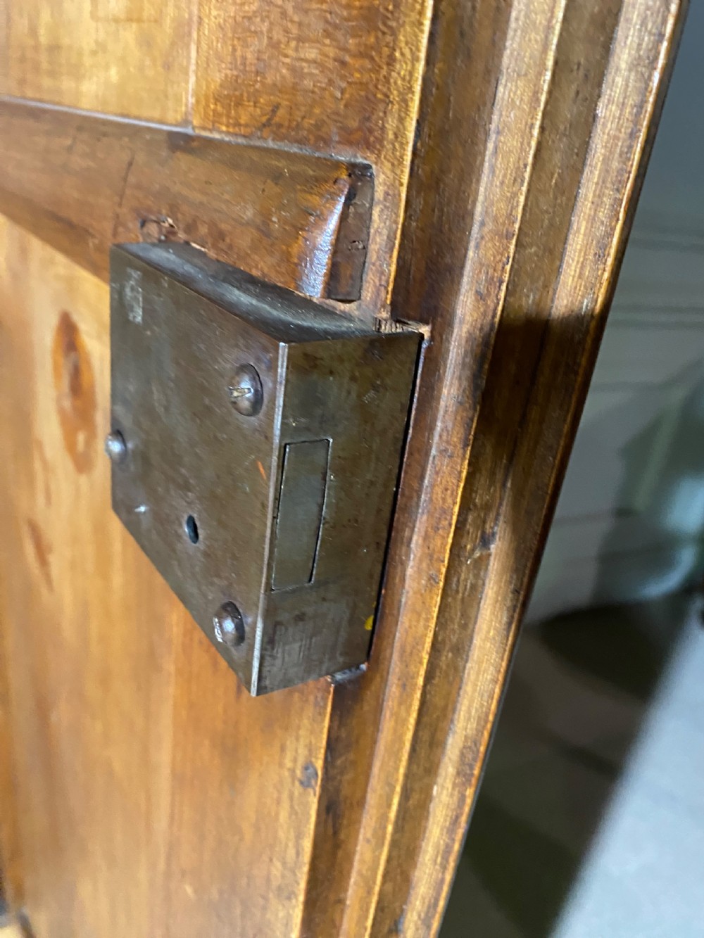 A tall 19th-century cherry wood armoire featuring double panelled doors, decorative iron keyplates, and a projecting upper cornice. View XVIII