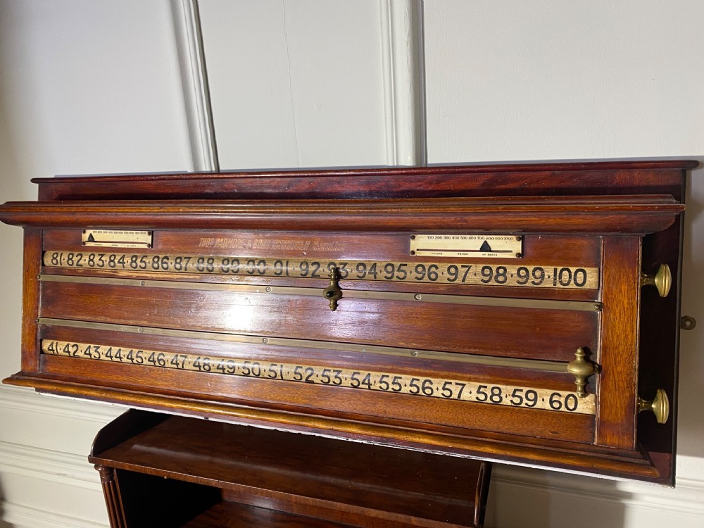 An antique Victorian mahogany and brass snooker scoreboard featuring sliding pointer markers and numbered tracks. View IX