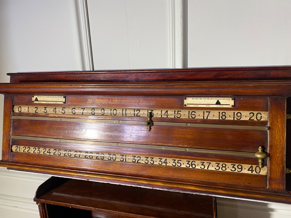 An antique Victorian mahogany and brass snooker scoreboard featuring sliding pointer markers and numbered tracks. View XI