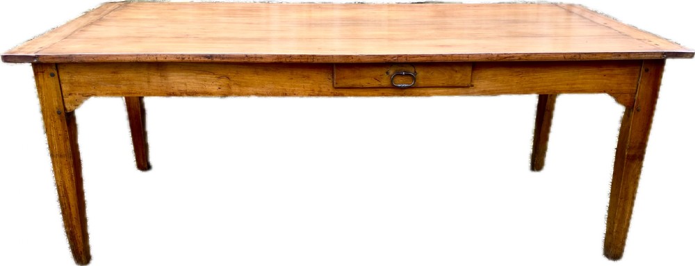 An early 19th-century cherry wood farmhouse dining table featuring a plank top, a single frieze drawer with an iron drop handle, and four square tapered legs.