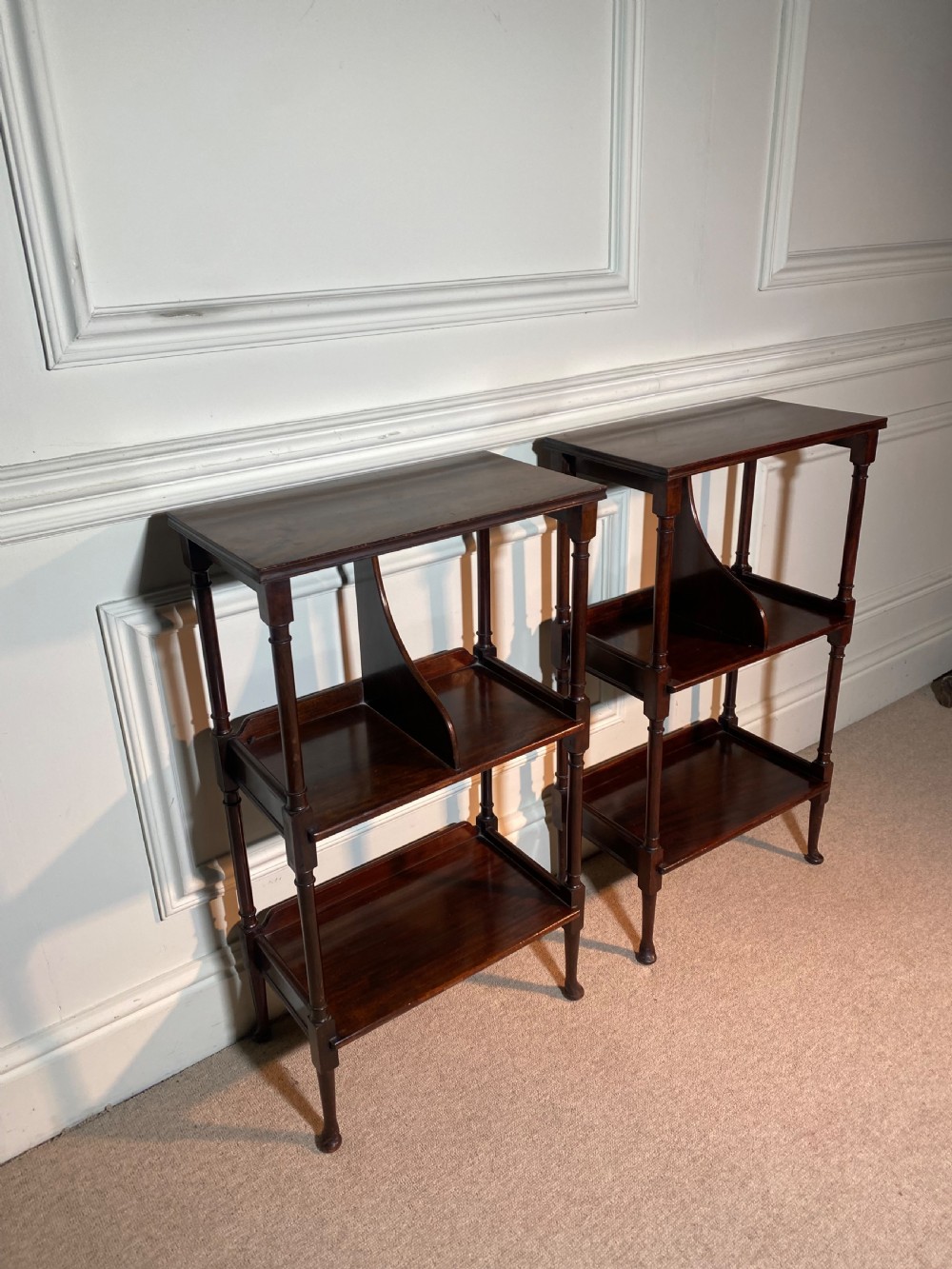 A pair of dark mahogany three-tier open bedside tables with turned supports and pad feet. View III