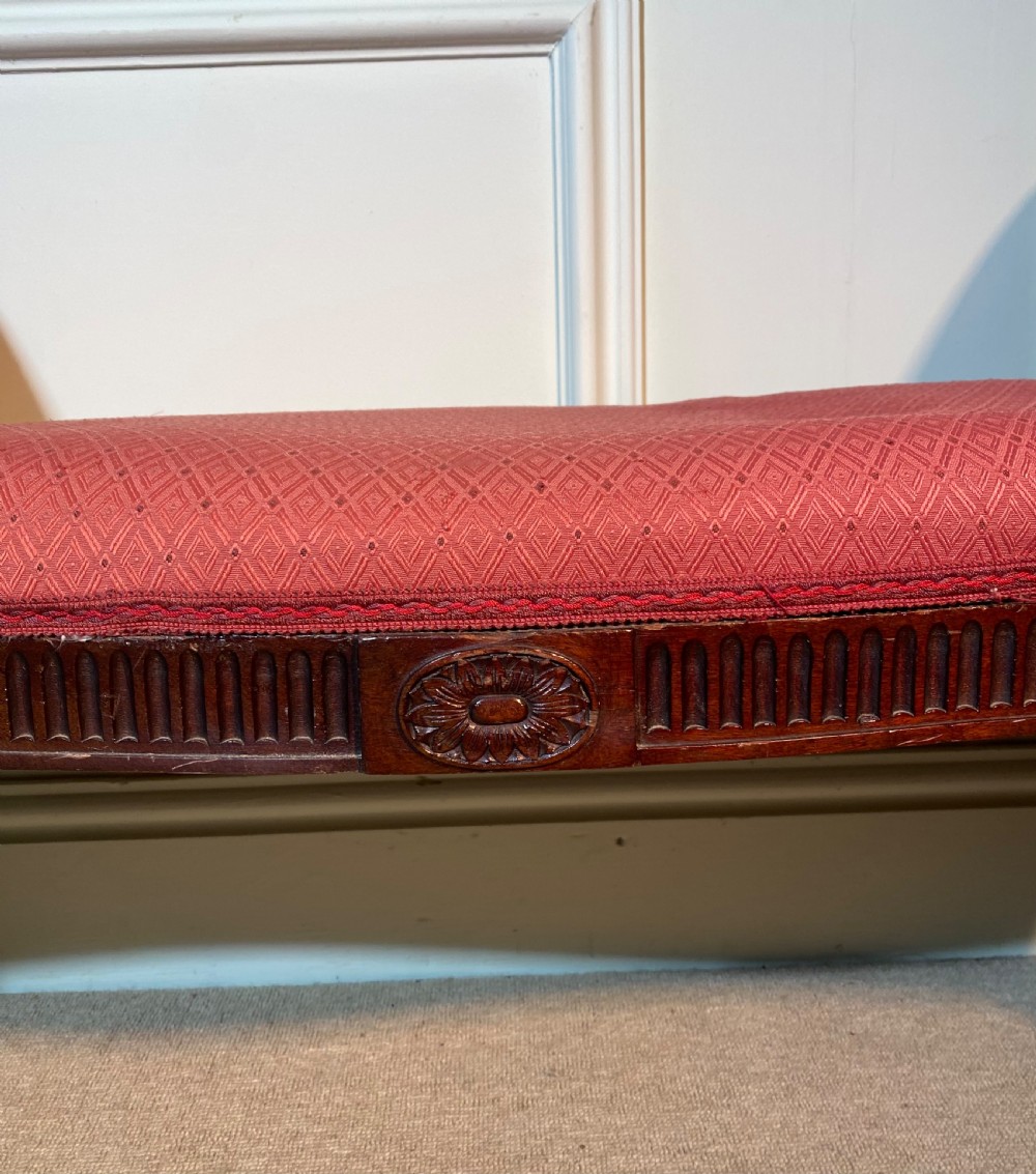 A Hepplewhite style window seat featuring rose pink patterned fabric upholstery, twin scrolled ends, and carved mahogany fluted legs. View III