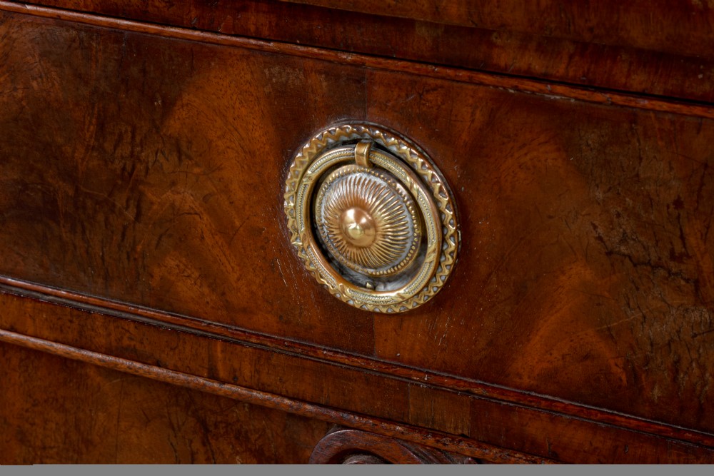 An antique Regency flame mahogany sideboard featuring spiral-turned legs, carved spandrels, multiple drawers, and brass ring handles. View VI