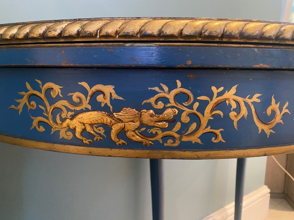 A dark blue lacquered demi-lune card table decorated with gilded Chinoiserie scenes, standing on slender legs with carved shell details. View II