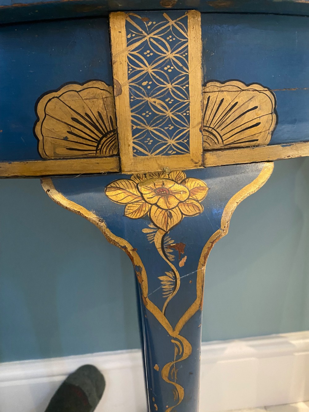A dark blue lacquered demi-lune card table decorated with gilded Chinoiserie scenes, standing on slender legs with carved shell details. View III