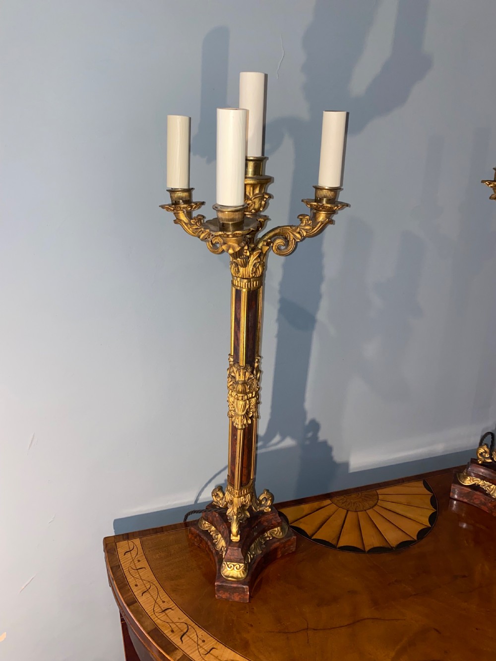 A pair of Neoclassical style gilt bronze and red marble candelabra table lamps featuring scroll arms and candle sockets. View II