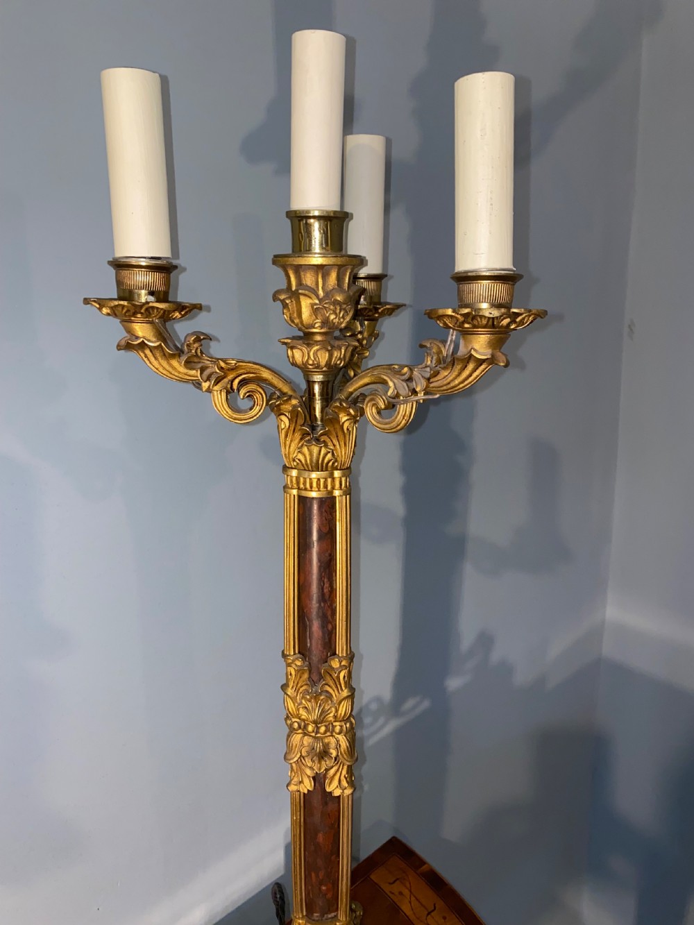 A pair of Neoclassical style gilt bronze and red marble candelabra table lamps featuring scroll arms and candle sockets. View III